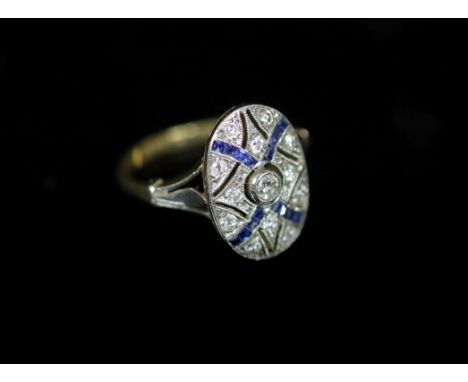 A 1920's gold and platinum, sapphire and diamond millegrain set pierced oval dress ring,size J/K, gross weight 3.1 grams.