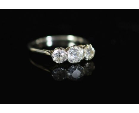 A white gold and three stone diamond set ring,the central old round cut stone weighing approximately 0.50ct and flanked by tw