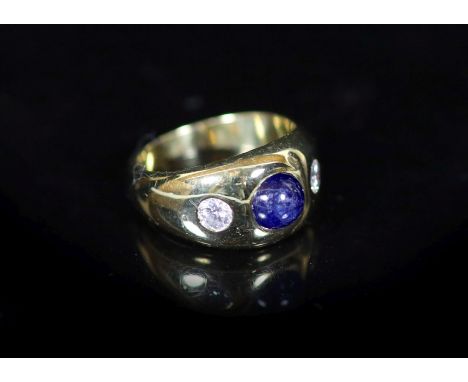 A Cartier 18ct gold , gypsy set cabochon sapphire and two stone diamond ring,signed Cartier, size M, gross weight 9.4 grams.