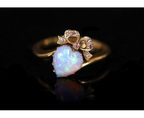 A late Victorian gold, heart shaped opal and diamond set crossover ring,with ribbon bow motif, size Q, gross weight 4 grams.