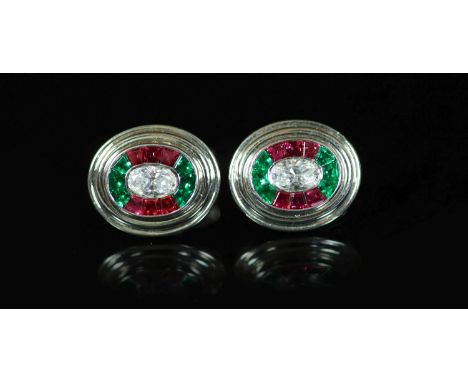 A pair of modern Asprey 18ct gold and platinum, ruby, emerald and diamond oval cufflinks,the central oval cut diamond weighin