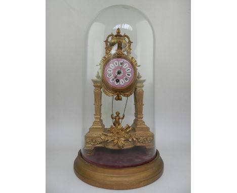 A late 19th / early 20th century French gilt metal portico clock, the circular pink enamel dial with tablet Roman numerals, t