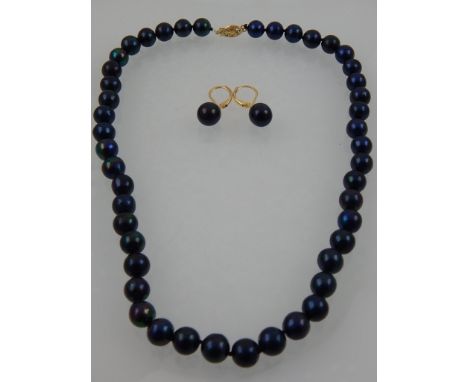 A natural black pearl necklace, having yellow metal clasp stamped 14k, together with a pair of yellow metal and black pearl d