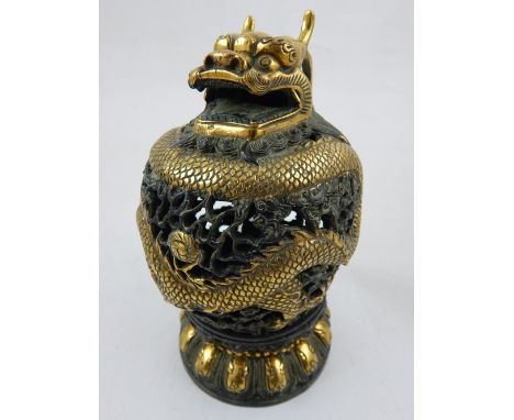 A Chinese gilt brass pierced ovoid incense burner, modelled as a dragon chasing a flaming pearl amongst clouds, raised on a c