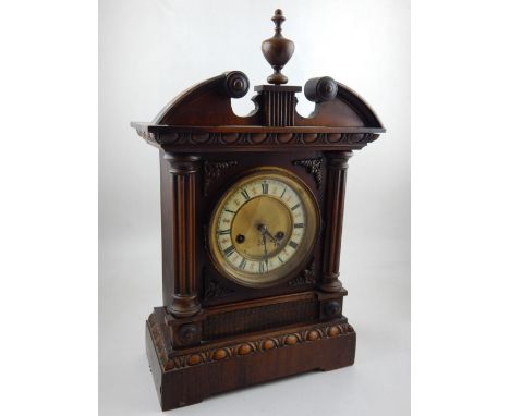 An early 20th century walnut cased 8 day mantel clock, the gilt dial with white enamel chapter ring marked Roman numerals
