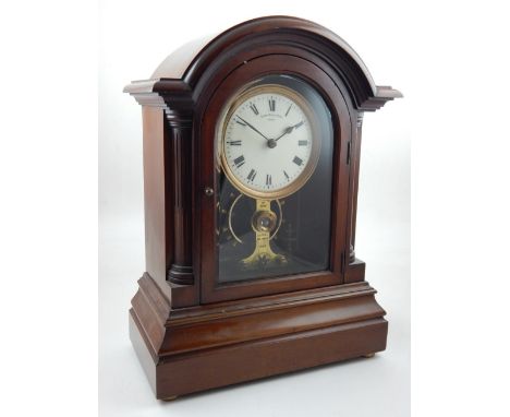 An early 20th century mahogany electric timepiece, by The Eureka Clock Co., Ltd., dated 1906, the circular enamel dial with R