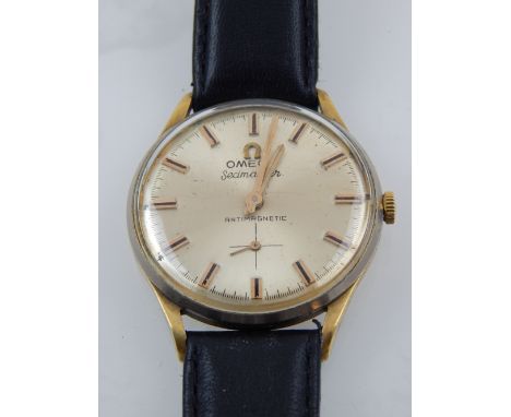 A gentleman's vintage goldplated Omega Seamaster wristwatch, with baton numerals and black leather strap