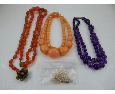 A dark purple amethyst necklace of two strands, having white metal clasp (stamped silver), together with a carnelian beaded n