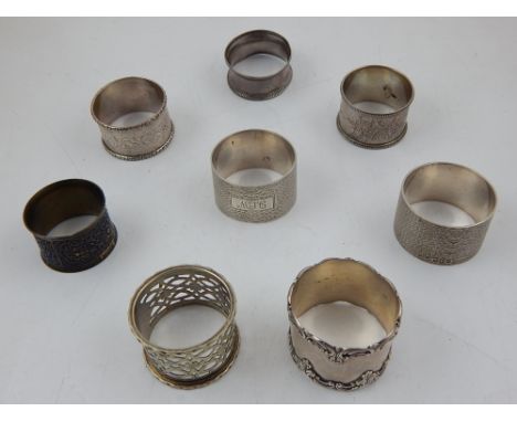 Six late Victorian/ Edwardian silver serviette rings with cast and engine tuned decoration together with two other serviette 