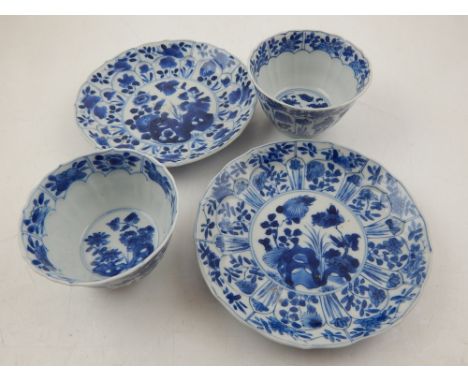 A pair of late 17th / early 18th century Chinese Kangxi period blue and white porcelain export cups and saucers, decorated wi