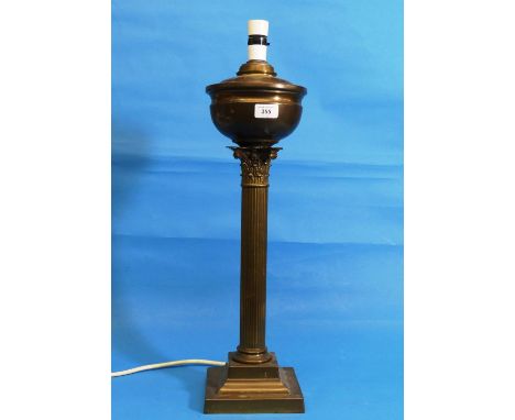 An early 20thC brass column Oil Lamp, H 59cm, later fitted with electricity, with a red lampshade (2) 