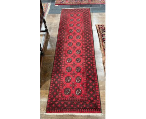 Tribal Rugs: a good red ground Afghan hand knotted Runner, the whole finely woven with tekke and guls within a wide geometric