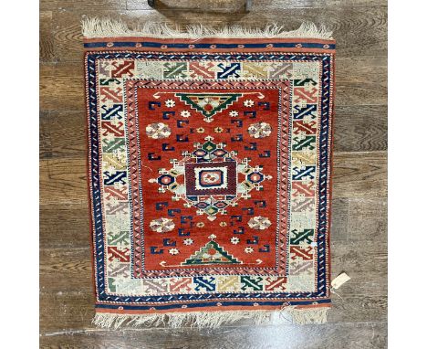 Tribal Rugs: a Turkish hand knotted wool rug, the orange ground woven with bold geometric patterns in dark blue, light blue, 
