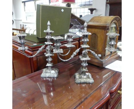 A pair of silver plated three light Candelabra, 34cm high,&nbsp;one with a damaged sconce&nbsp;(2) 