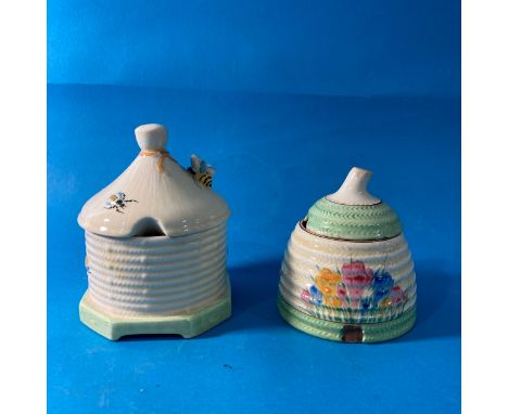 A Clarice Cliff 'Spring Crocus' pattern Honey Pot, with green banding, marls for Newport, together with Crown Devon Skep in t