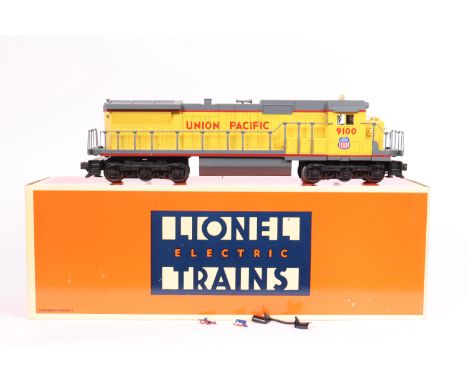 Lionel Electric Trains 3-rail O gauge American outline locomotive and 3 freight cars. A Dash-8 twin bogied 12 wheeled heavy f