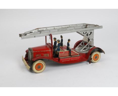 A scarce Tinplate windup Fire Engine in red with extending  ladder and 4 firemen figures, Made in England stamped to the fron
