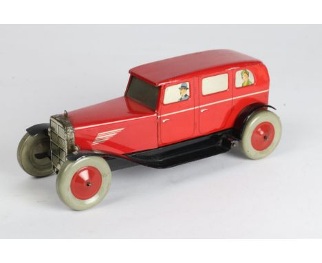 A scarce CHAD VALLEY Tinplate  saloon car finished in red with litho figures to the windows, grey tyres with red centres. Clo