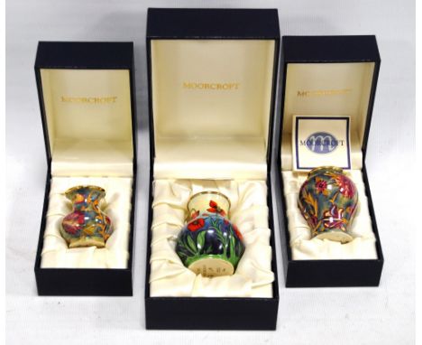 Three Moorcroft enamel vases, all boxed, the largest 6.5cm high. Condition Report All in good condition.
