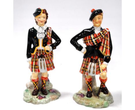 Pair of Radnor bone china figures of a Scottish couple wearing Royal Stewart tartan kilts, 17cm high.