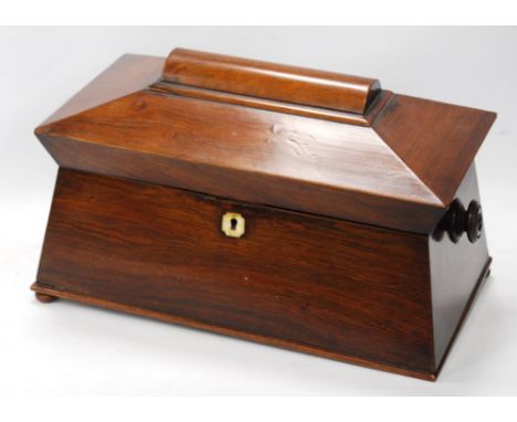 Regency rosewood sarcophagus shaped tea caddy with ivory escutcheon, lacking mixing bowl, 19cm high and 34cm wide.