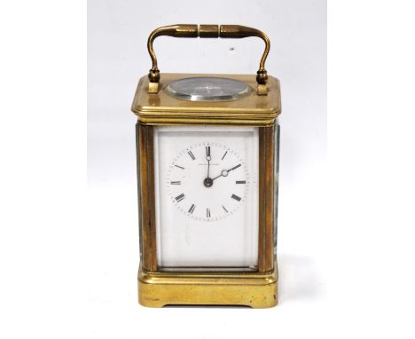 Early 20th century French brass carriage clock, makers Howell & James of Paris, with Roman enamel dial, the compensated lever