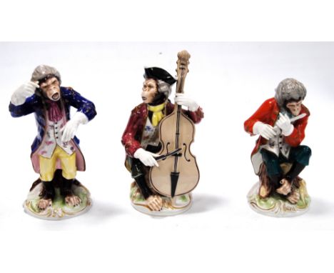 Three 20th century continental porcelain monkey band figures, un-marked, 15cm high.