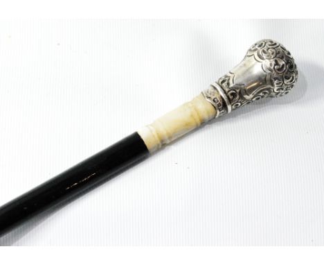 Ebonised cane with mother of pearl and embossed silver knop, maker's mark not clear, 1905, 77cm. Condition Report Shortened.