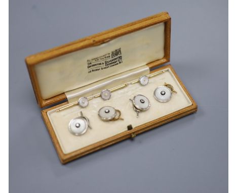 A cased set of four 1940's 18ct &amp; Pt, mother of pearl and diamond set dress studs, gross 8.1 grams and three other studs 