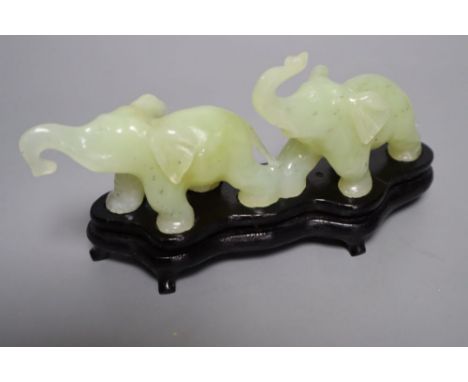 A carved bowenite jade group of two elephants, 16cm long with stand, boxed