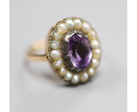 A 19th century, 9ct, amethyst and split pearl set oval cluster ring, size L, gross 5 grams.CONDITION: Amethyst has a chip to 