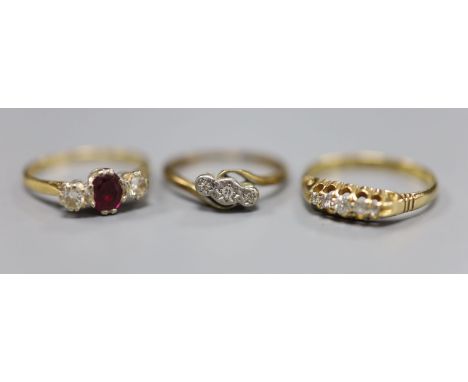 A ruby and diamond three-stone ring, in 18ct gold and platinum setting and two diamond-set rings, a five-stone 18ct gold and 