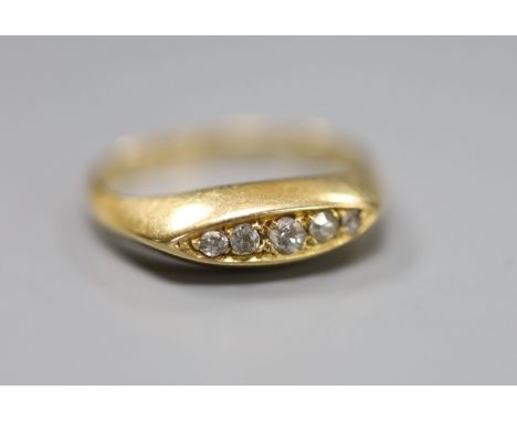 An 18ct gold and five stone diamond set half hoop ring, size J, gross 3 grams.