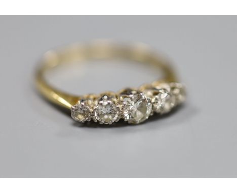 An 18ct and plat, graduated five stone diamond set half hoop ring, size N, gross 2.2 grams.