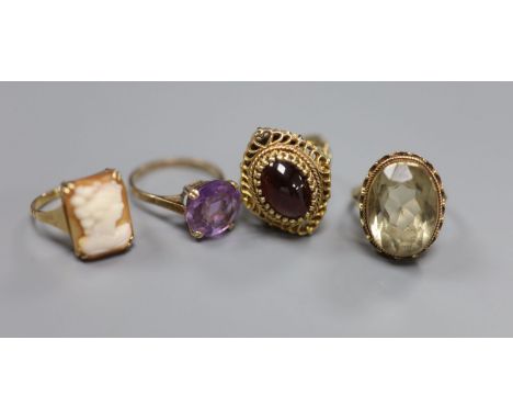 A Renaissance style cabochon garnet ring, 9ct gold stepped pierced setting, 7.2g and three other 9ct dress rings, comprising 