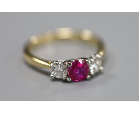 A modern 18ct gold and platinum, ruby and diamond set three stone ring, size M, gross 3.3 grams.CONDITION: Overall nice clean