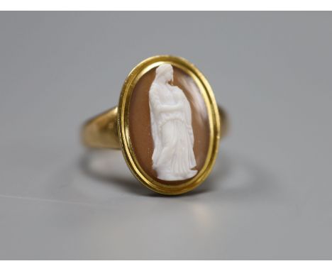 A 19th century yellow metal and oval cameo hardstone ring, carved with the figure of a lady with an urn, size R, gross 4.6 gr