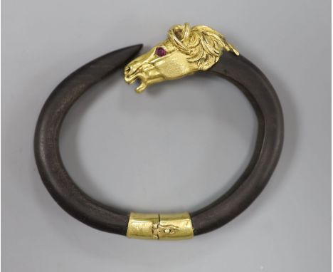 A continental yellow metal and gem set mounted wooden? bangle, with horse head terminal, gross 40 grams, indistinct marks,