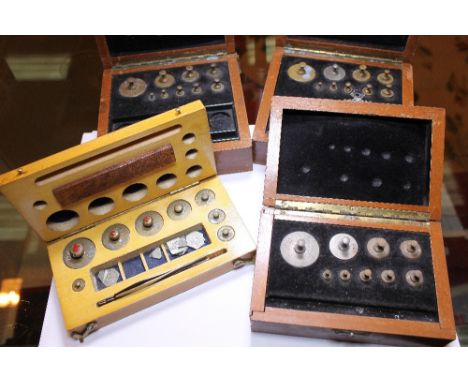 Four boxes of antique scientific and jeweller's scale weights