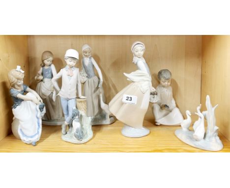 Six and one other Nao porcelain figurines of children, H. 25cm.
