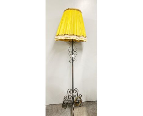 A vintage wrought iron standard lamp with original shade, rewired and PAT tested, H. 170cm.