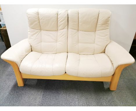 A cream leather Ekornes Stressless reclining two seater Buckingham sofa on a light ash frame, W. 172cm H. 103cm D. 74cm.
