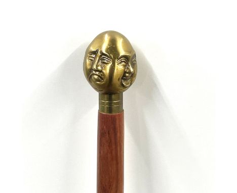 A four faced Buddha head walking stick, L. 92cm.