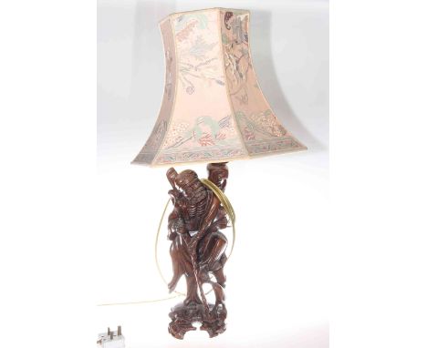Carved Oriental figure lamp with silk shade