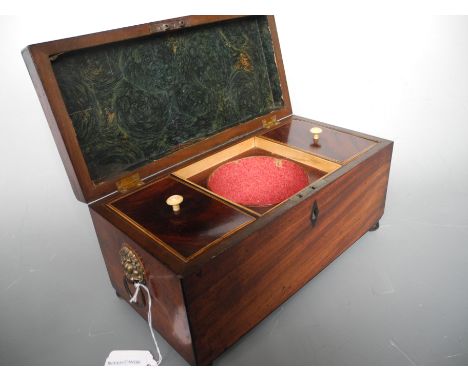 A 19th Century mahogany tea caddy on brass feet.