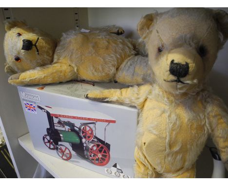 A boxed mamod steam tractor and two teddy bears.