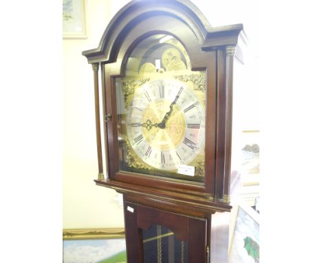 A reproduction mahogany cased hall clock with brass weights.