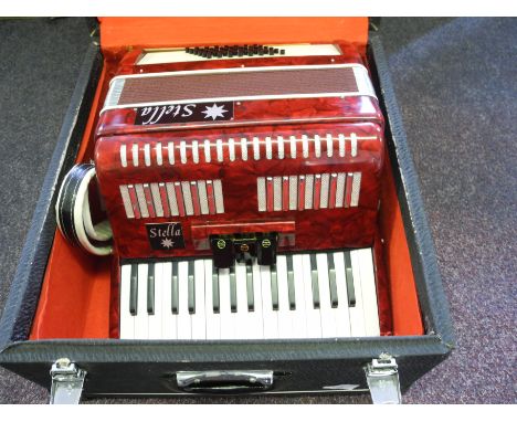A cased stella accordion.