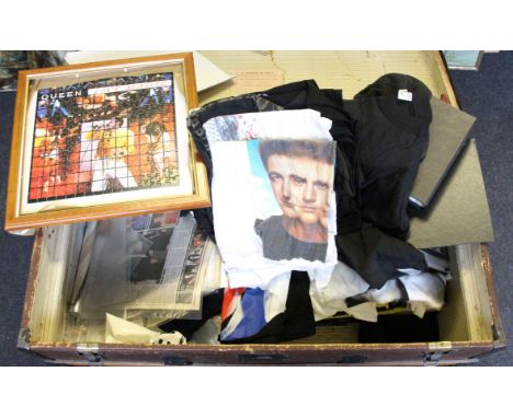 A trunk of assorted Queen memorabilia and ephemera items to include; jigsaws, posters, clothing, magazines etc.