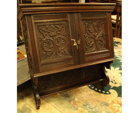 A circa 1900 carved oak two door hanging wall cupboard with shelf CONDITION REPORTS Overall condition good though with some a